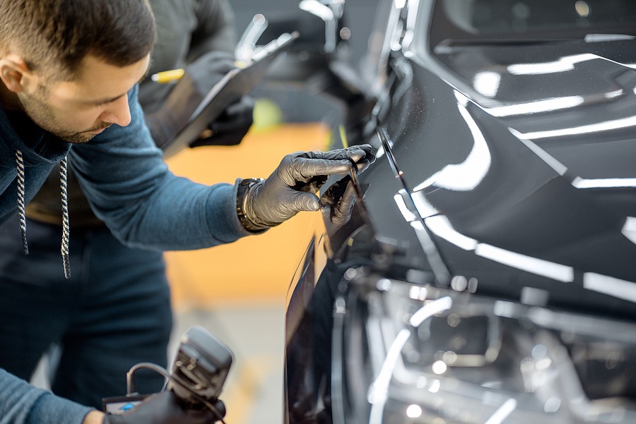 bigstock Car Service Worker Examining V 354492014